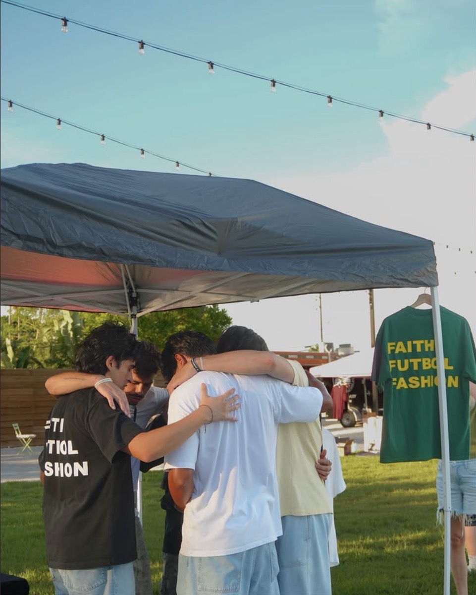 Praying together by a vendor tent