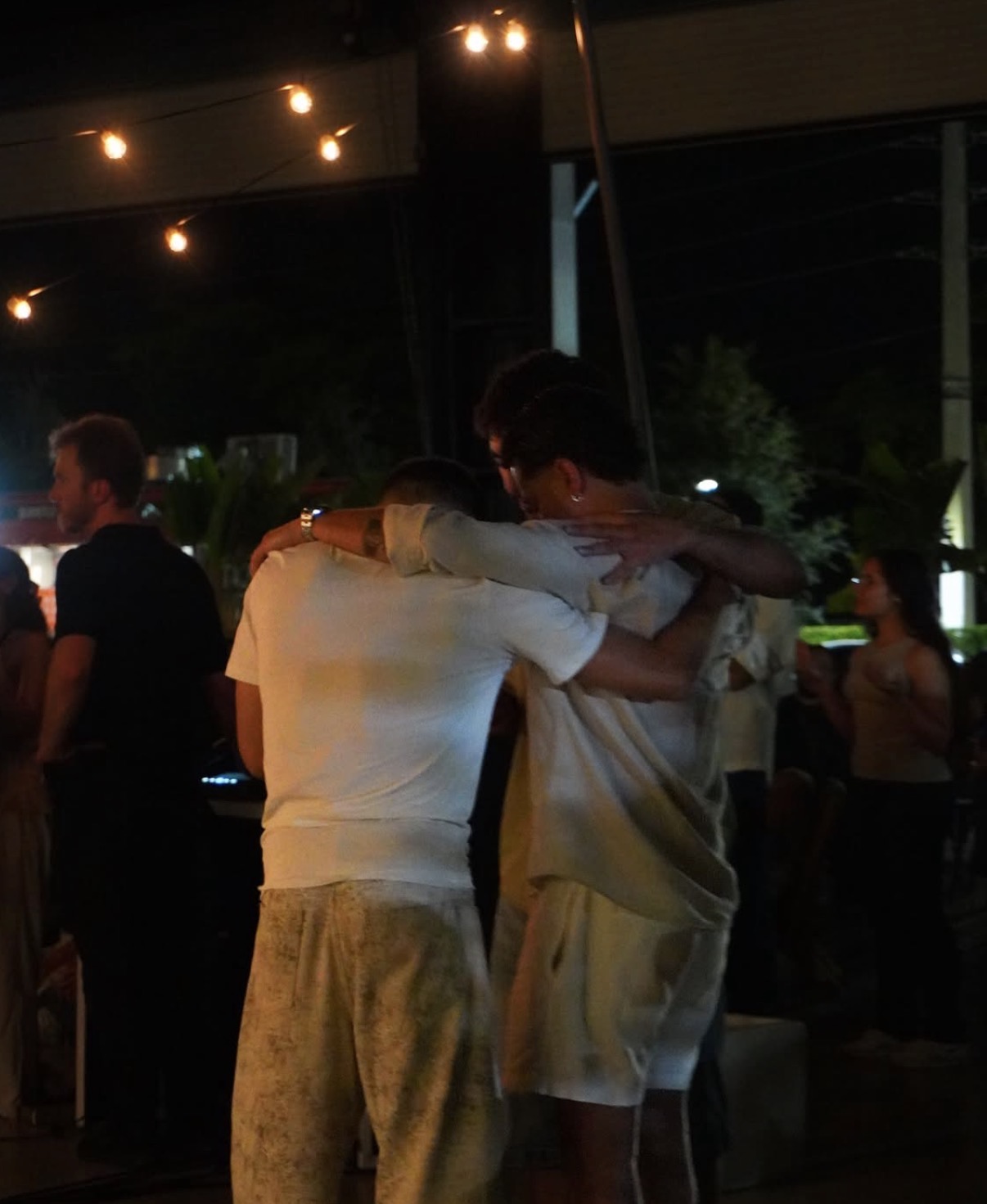 Friends embracing at night
