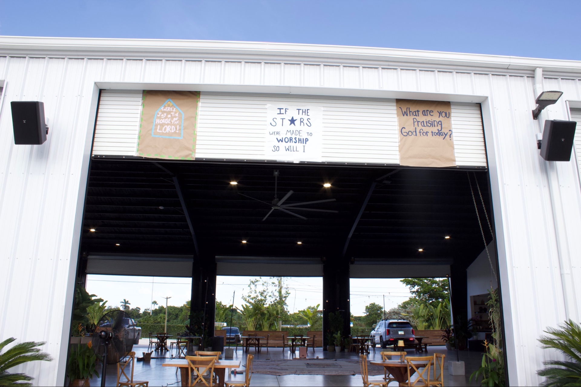 The open gathering venue with worship banners above the entrance